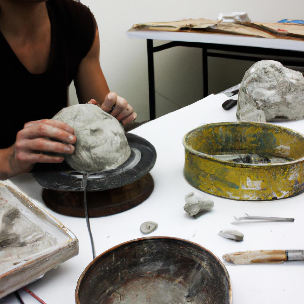 Artist sculpting clay in studio