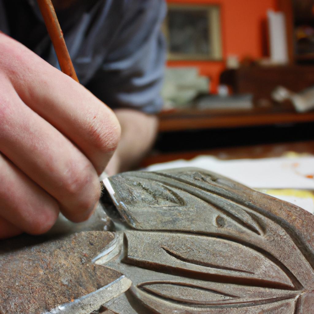 Person carving intricate design into woodblock
