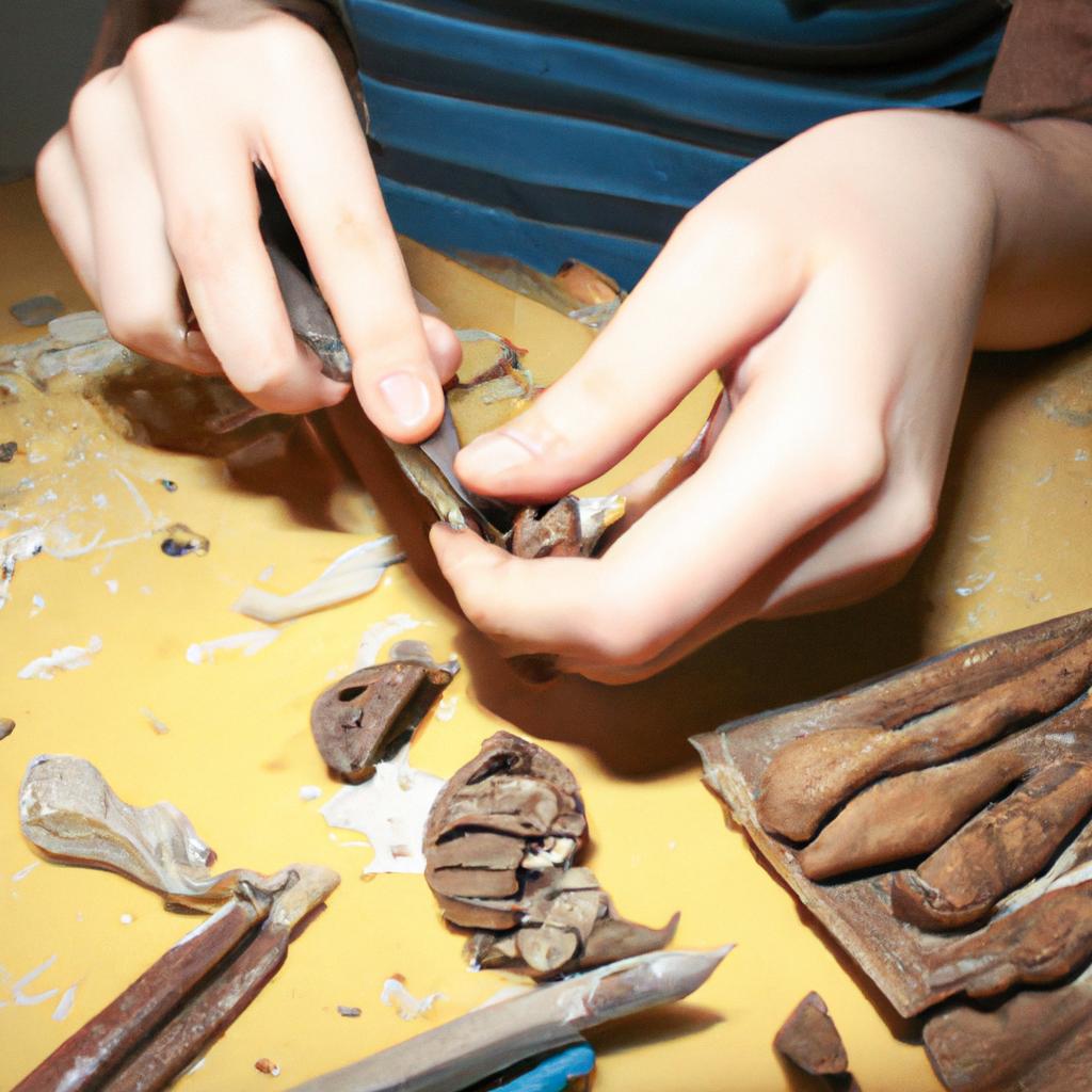 Person sculpting clay with tools